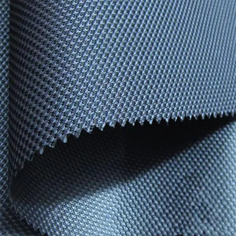 What is the specific advantage of Polyester Filament Fabric's low shrinkage?